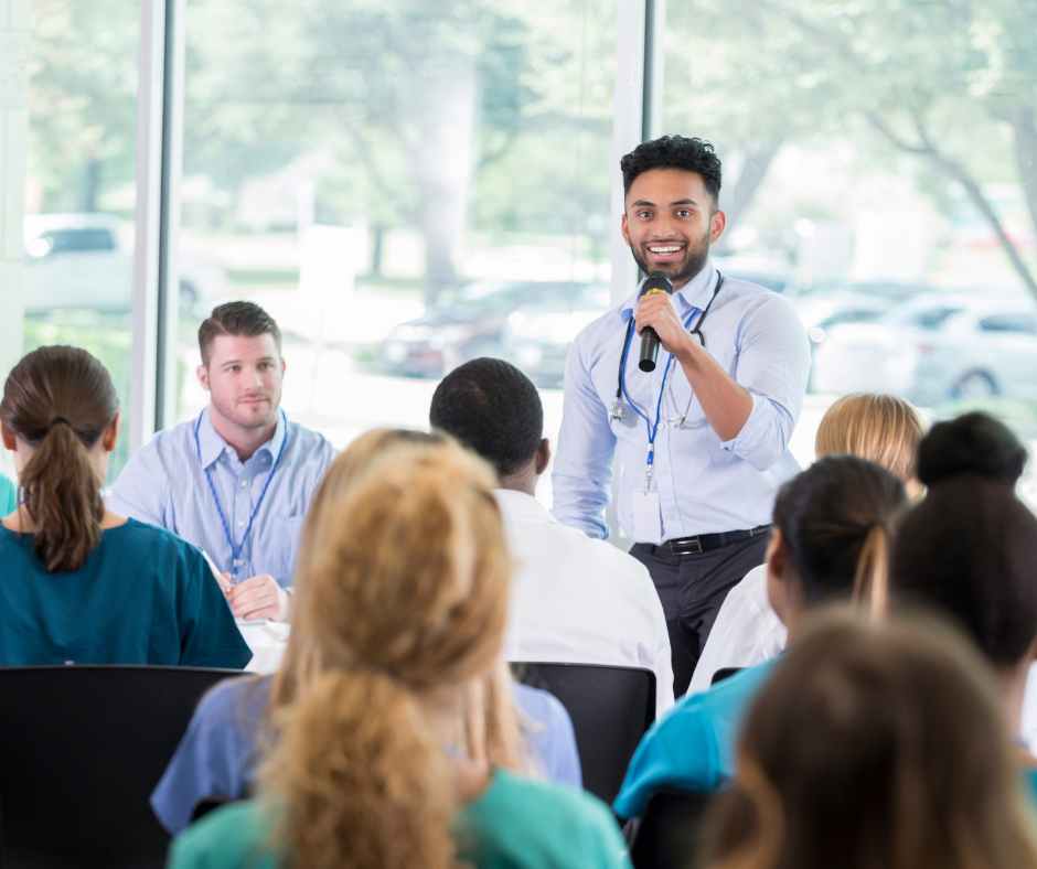 meeting with several people, one talking, medical conference